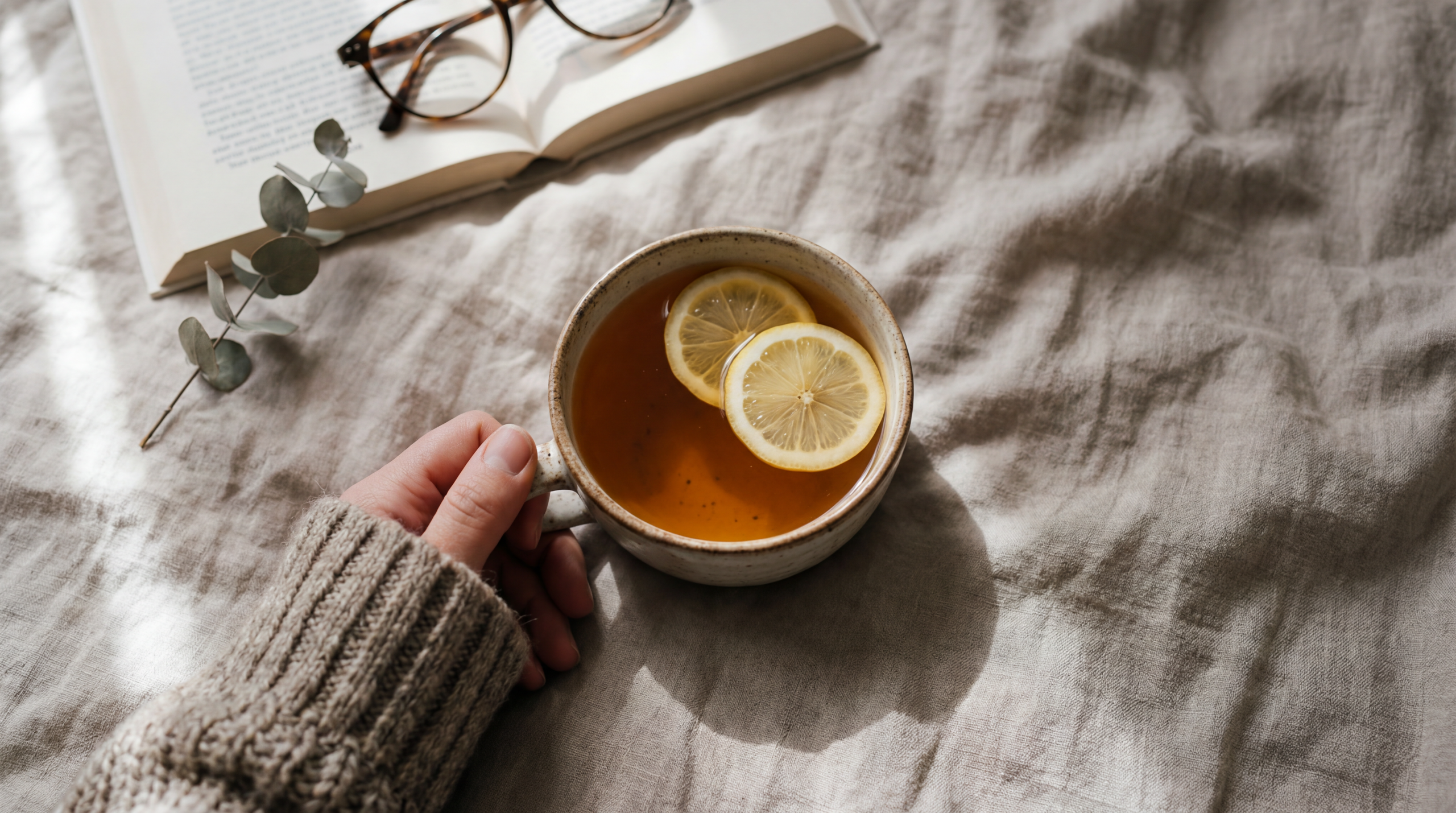 Soft morning light in a calm interior, a cup of tea in hand